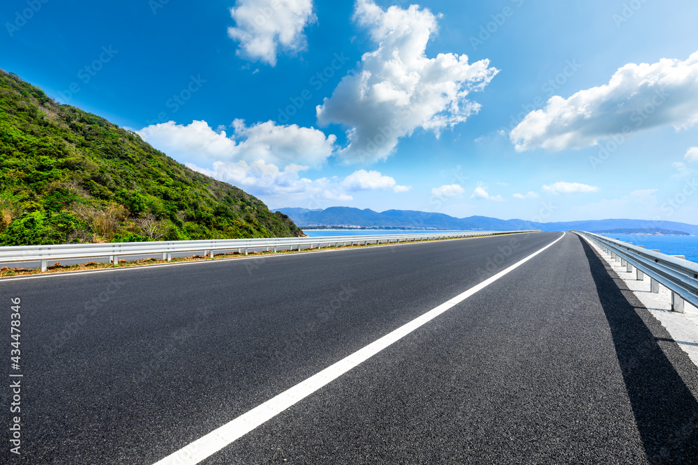 Mountain highway with blue sky and sea landscape.