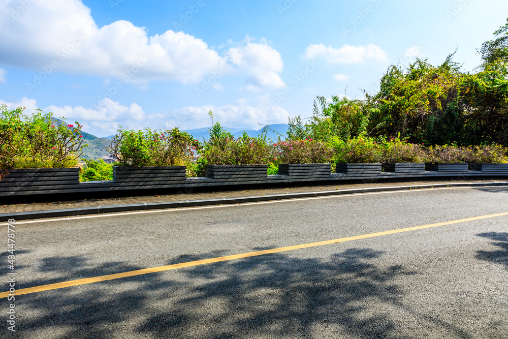 Mountain road landscape under blue sky.