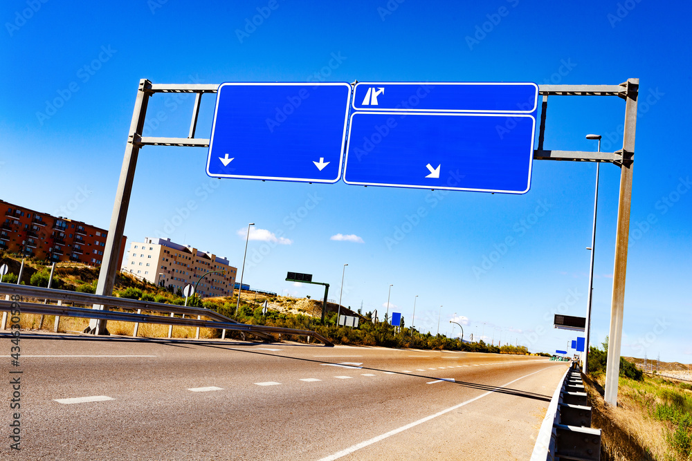 Señal de carretera. Carretera vacía a través de la ciudad con una señal de tráfico en blanco