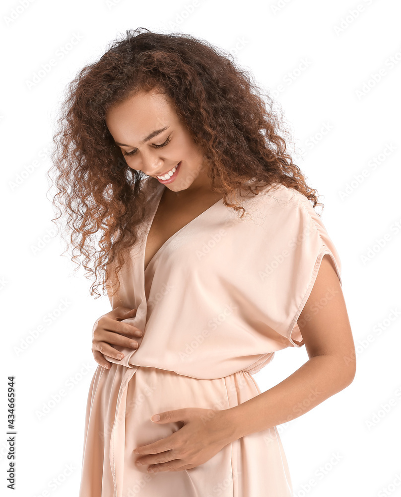 Beautiful pregnant African-American woman on white background