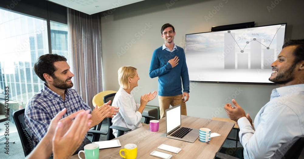 Several colleagues clapping businessman after her presentation of data and analisis at the office