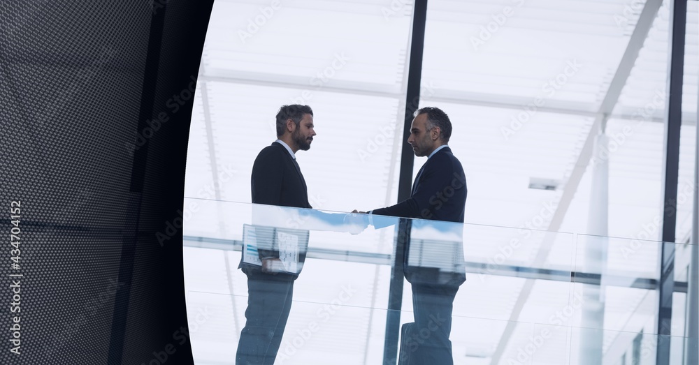 Technology background over two businessmen shaking hands at modern office