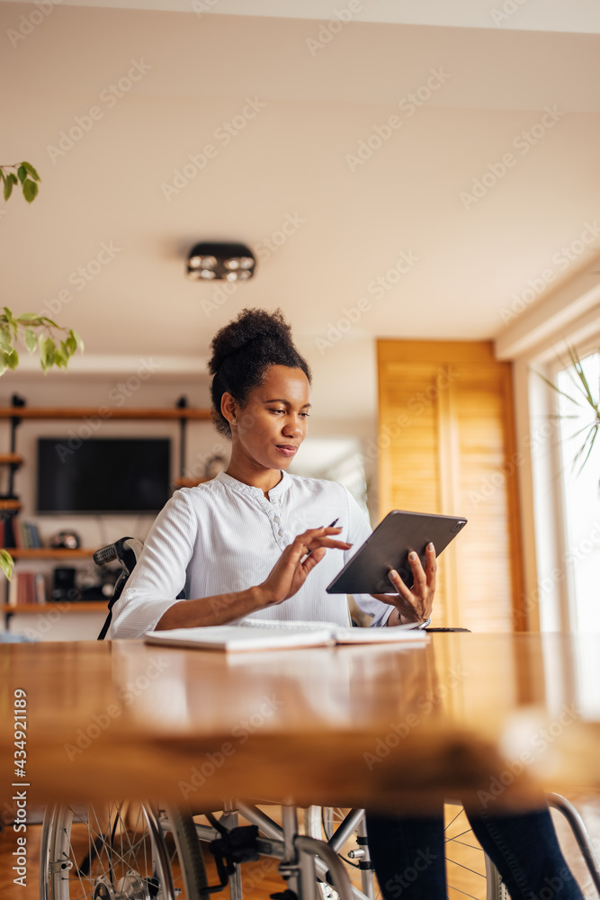 Adult African female using modern technology, typing something.