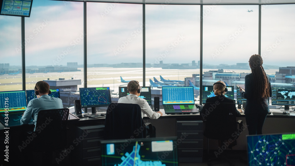 Diverse Air Traffic Control Team Working in a Modern Airport Tower. Office Room is Full of Desktop C