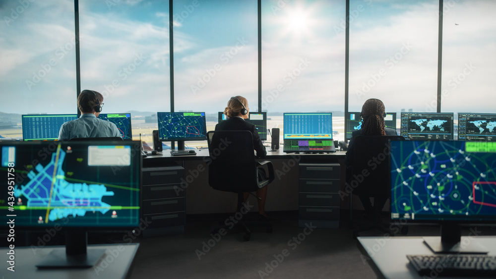 Diverse Air Traffic Control Team Working in a Modern Airport Tower. Office Room is Full of Desktop C