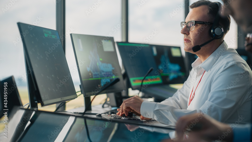 Male Air Traffic Controller with Headset Using Touchscreen Table Panel in Airport Tower. Office Room