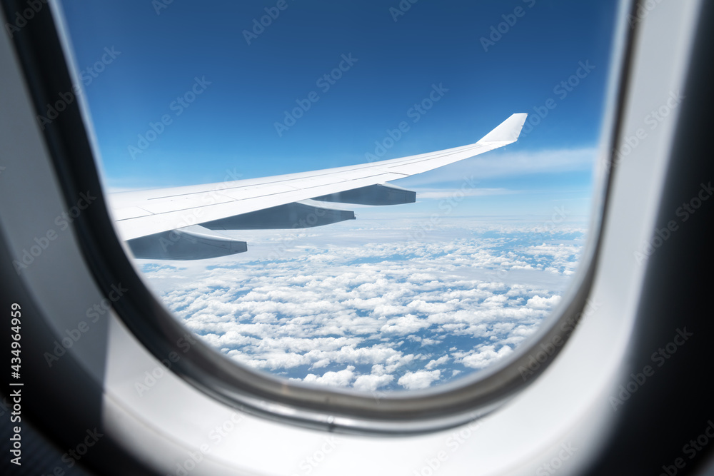 View of clouds and wing from a plane window