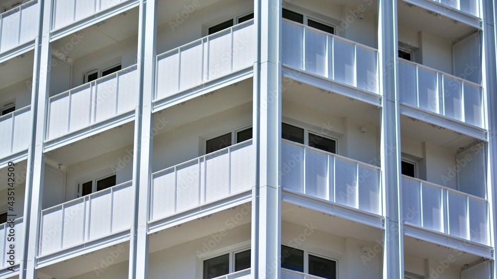 Condominium and apartment building with  symmetrical modern architecture in the city downtown.