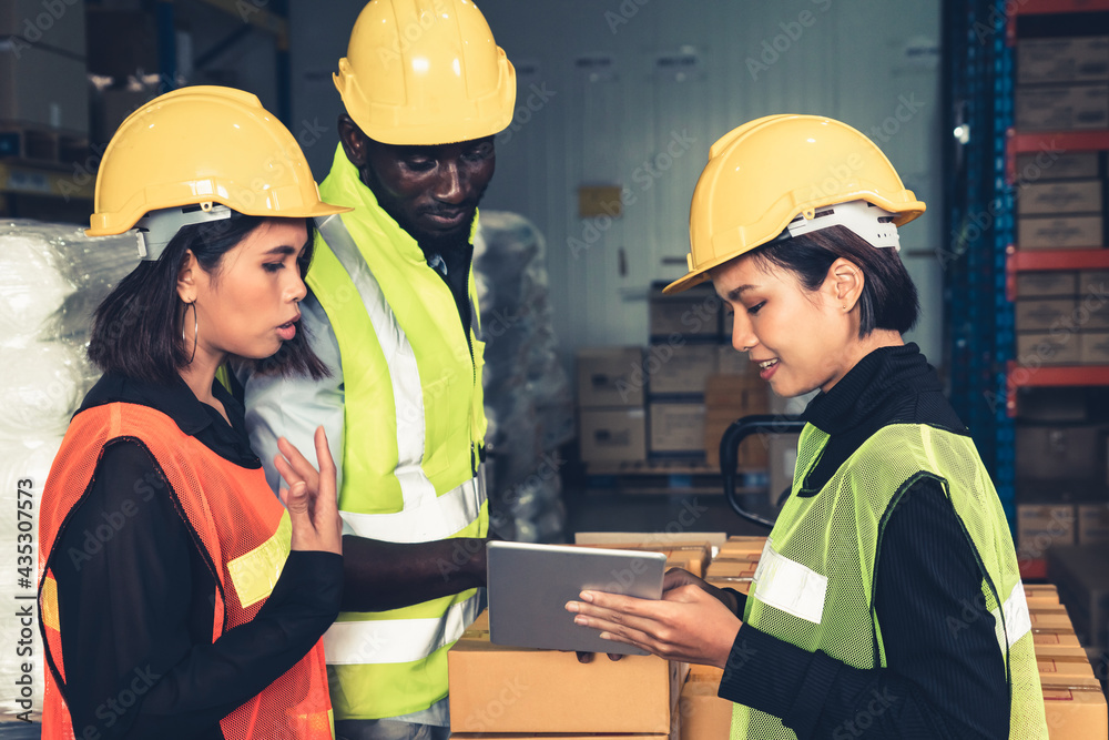 Warehouse worker working together in the storehouse . Logistics , supply chain and warehouse busines