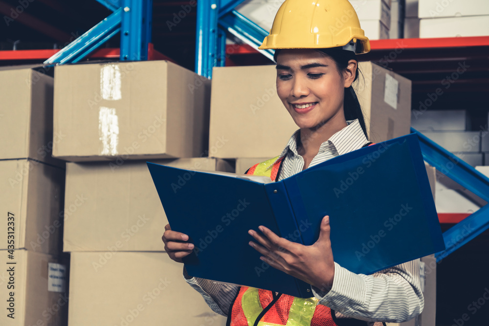 Female warehouse worker working at the storehouse . Logistics , supply chain and warehouse business 