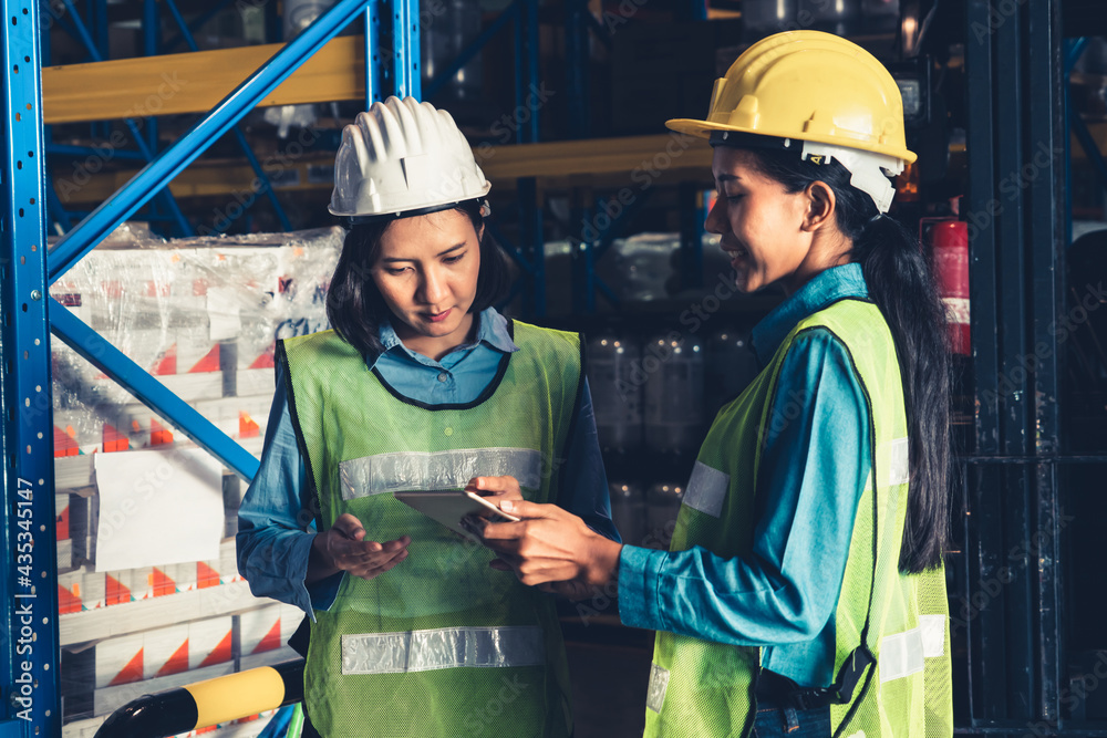 Female warehouse worker working at the storehouse . Logistics , supply chain and warehouse business 