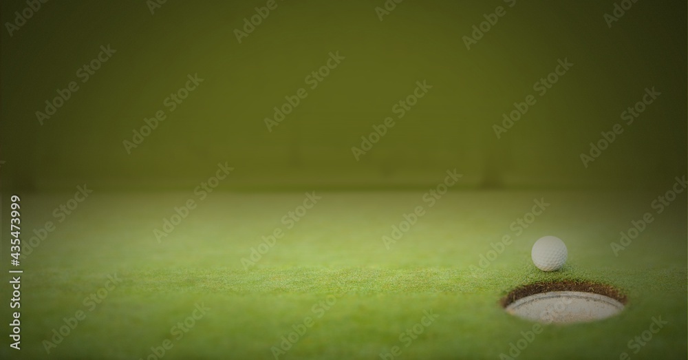 Composition of golf ball on golf course over green blur