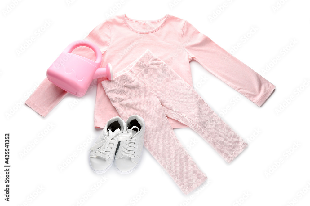 Childrens clothes and toy on white background