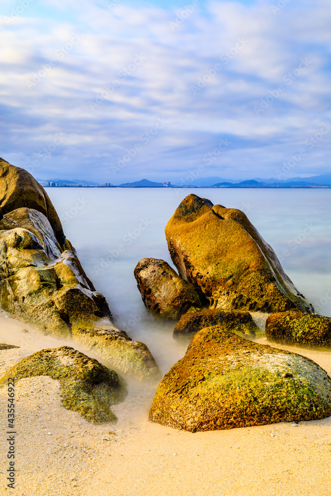 Landscape with beach,the sea and the beautiful clouds in the blue sky.rocks on the beach.