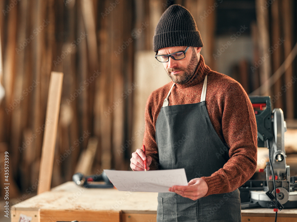 Craftsman working with papers in workshop