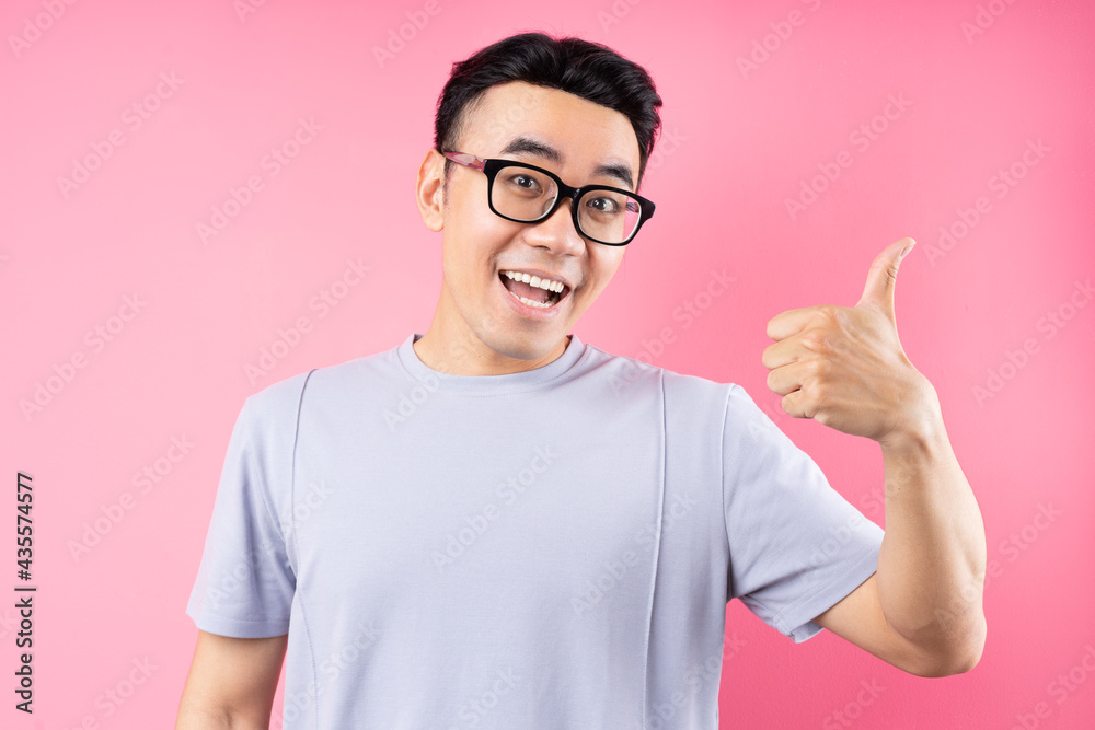 Portrait of Asian man posing on pink background with many expression