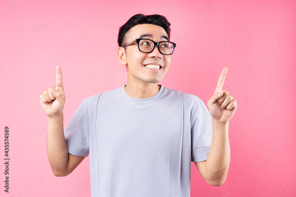 Portrait of Asian man posing on pink background with many expression