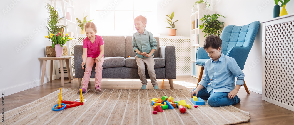 Playful children sitting in the living room on the Birthday party.