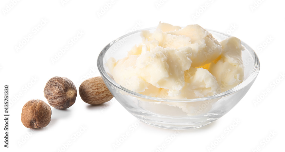 Bowl with shea butter and nuts on white background