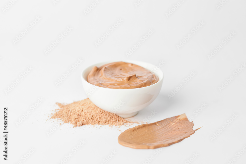 Bowl with cosmetic clay on white background