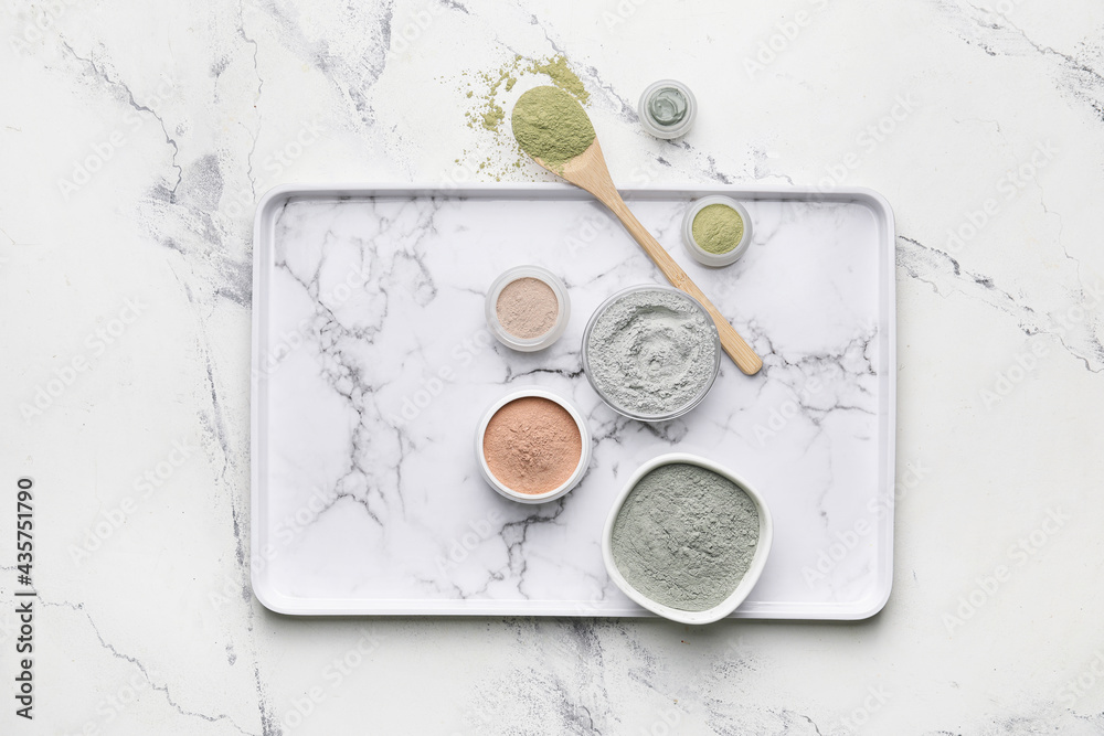 Tray with cosmetic clay on light background