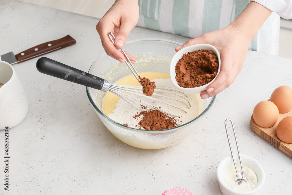 Woman preparing pastry in kitchen