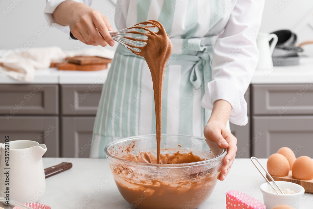 Woman preparing pastry in kitchen