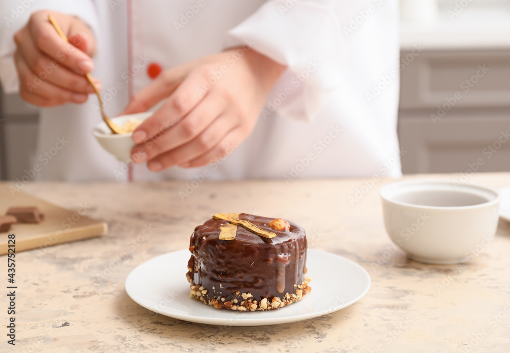 Woman cooking chocolate cake in kitchen