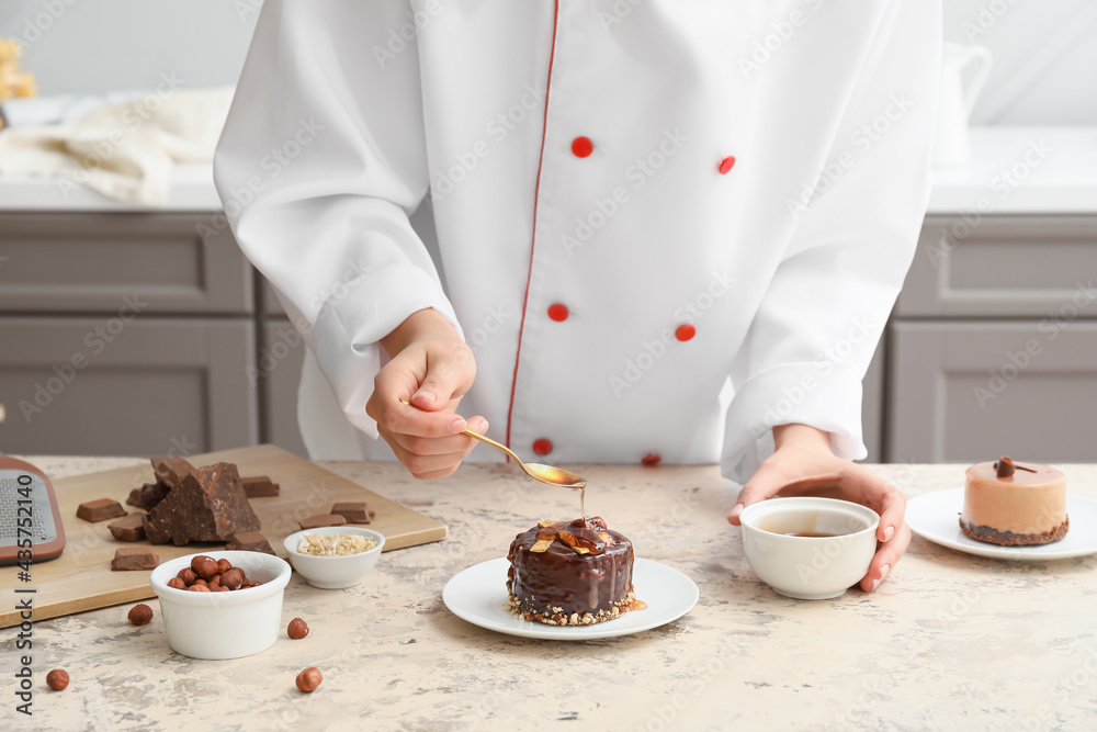 Woman cooking chocolate cake in kitchen