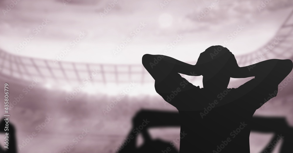 Composition of silhouette of sport fans in sports stadium with glowing spotlights