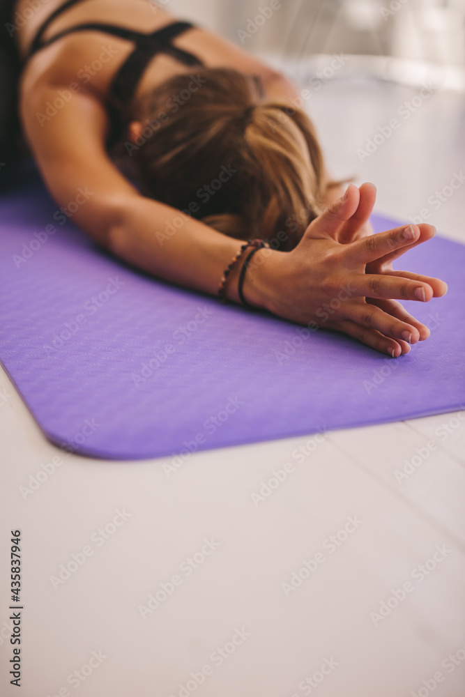 Woman doing child pose yoga at gym