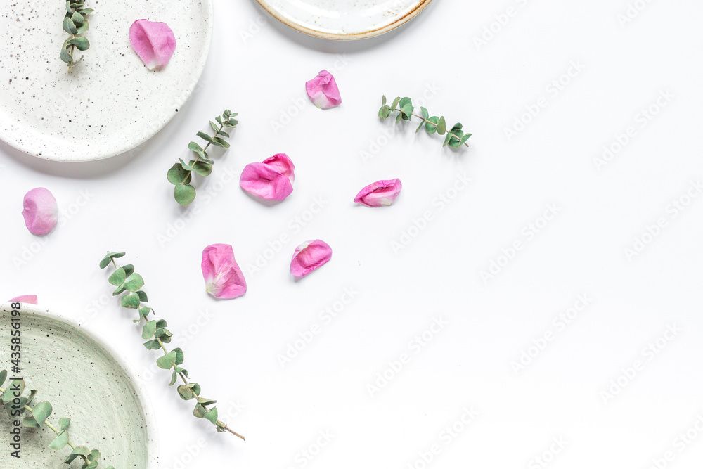 trendy woman desk with rose petals and plate top view mock-up