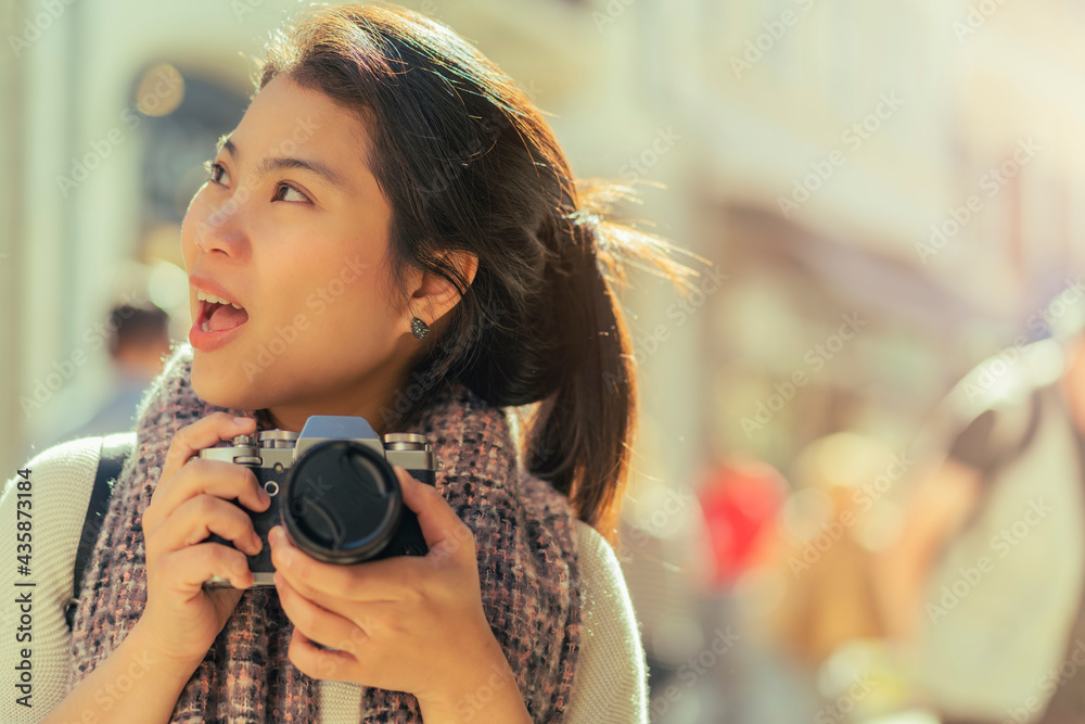 asian female traveller hand hold camera walking tour and  take photo of lifestyle people city people