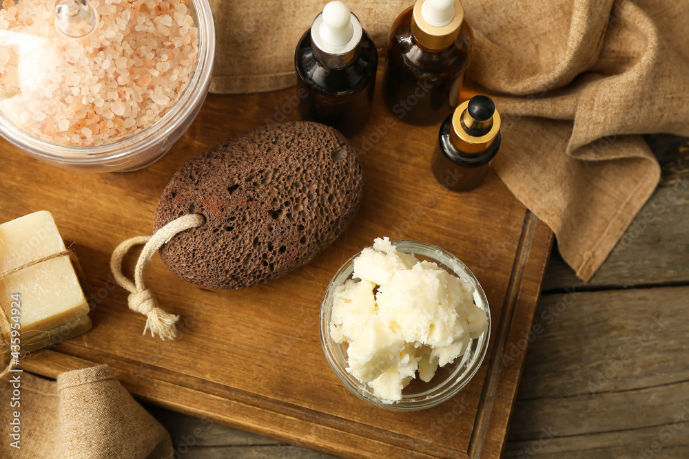 Composition with shea butter, essential oil and bath supplies on wooden background