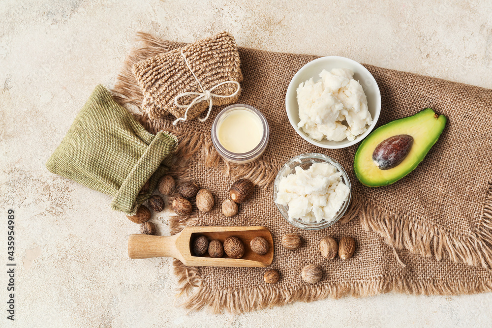 Spa set with shea butter and nuts on light background