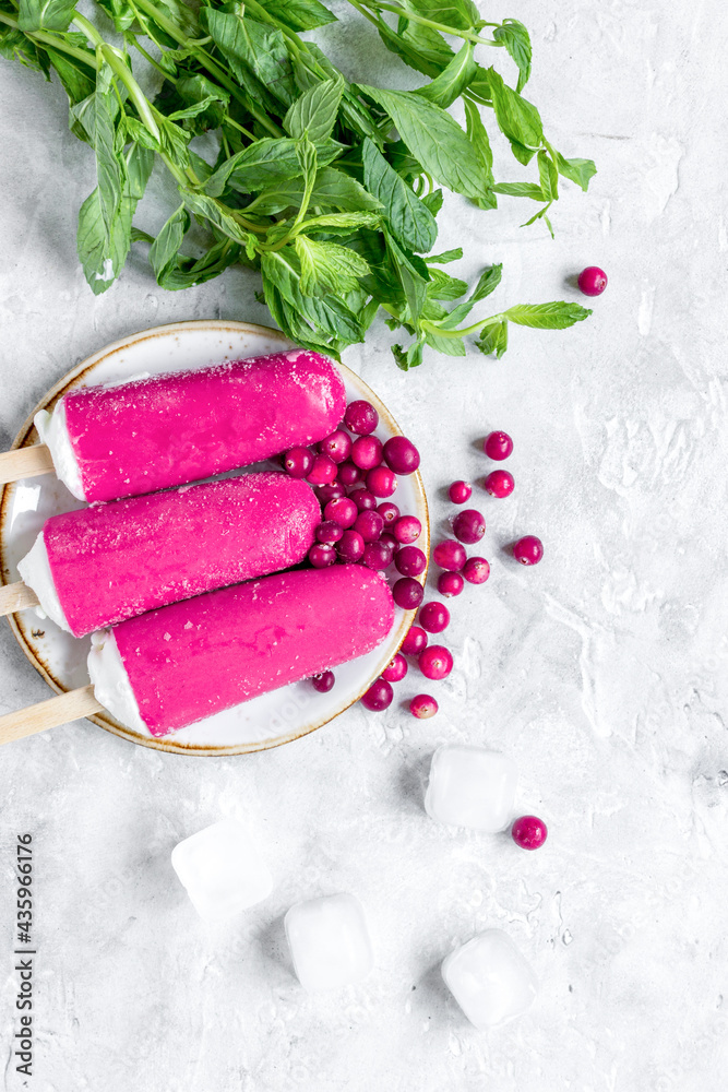 summer dessert with popsicle and red berries stone desk background top view