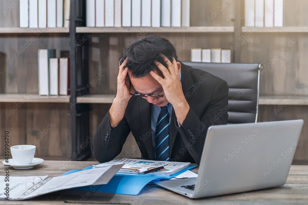 asian business man having a stress and headache working in office