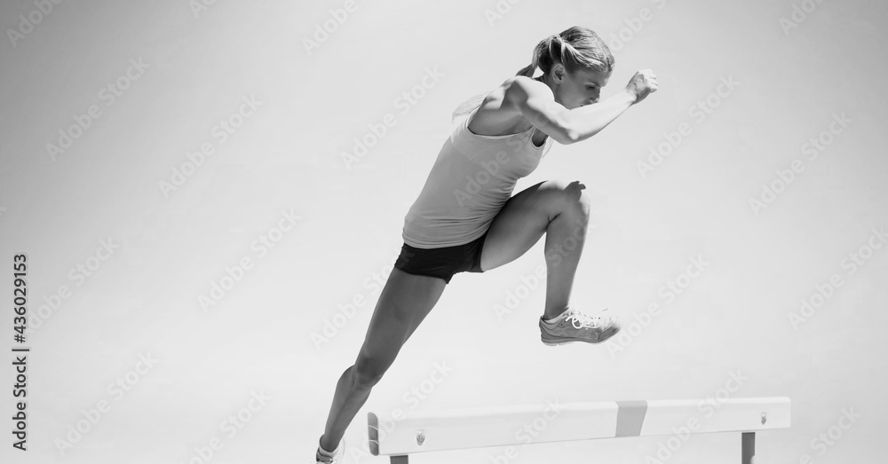 Composition of female hurdle jumper with copy space in black and white