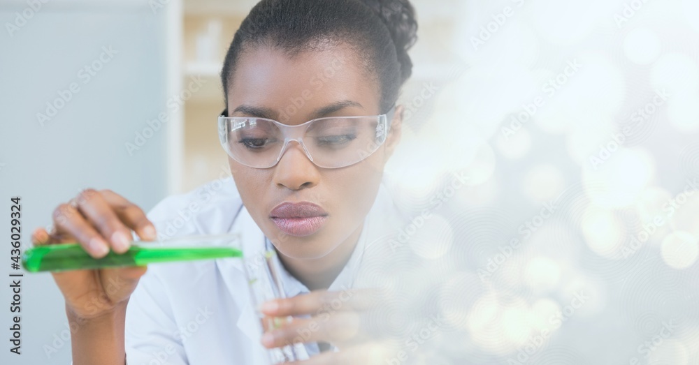 Composition of female scientist holding test tube with green liquid in laboratory and copy space