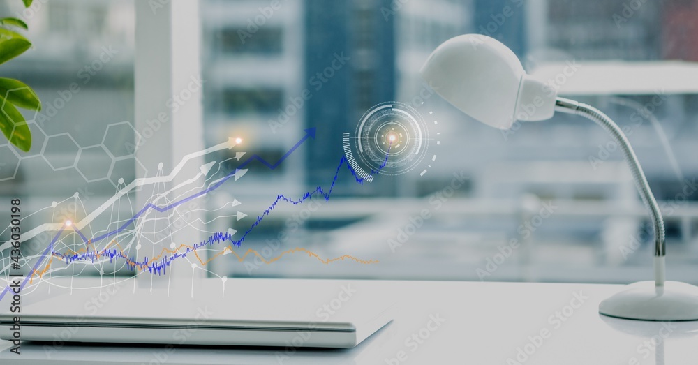 Composition of closed laptop on office desk with virtual medical research data interface screen