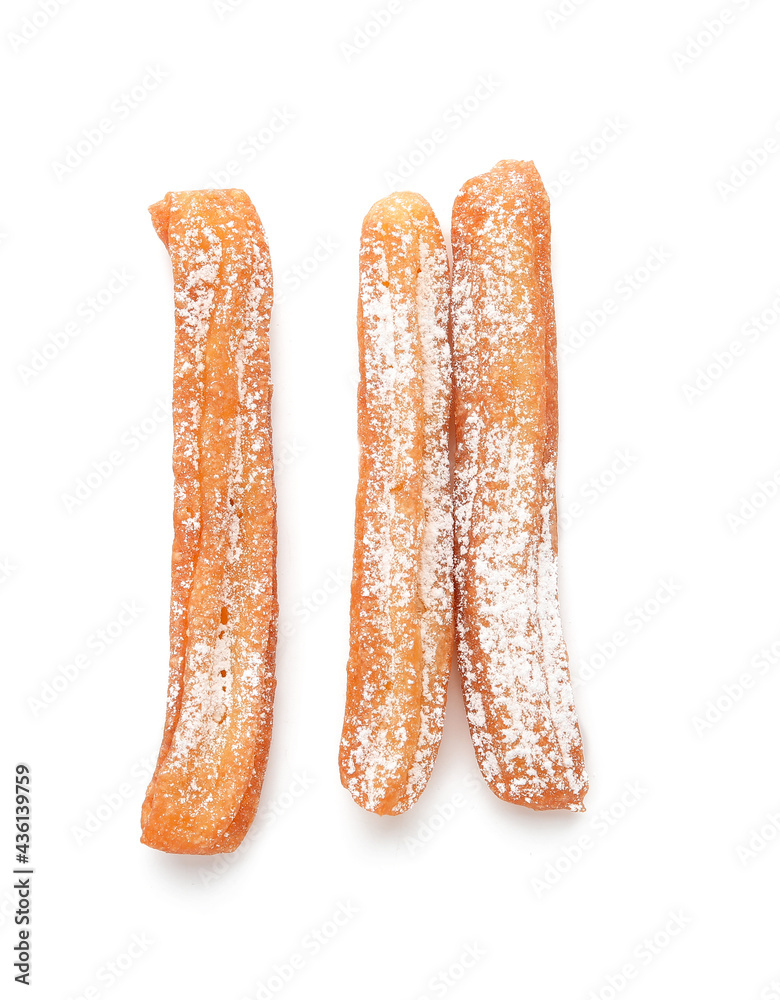 Tasty churros on white background