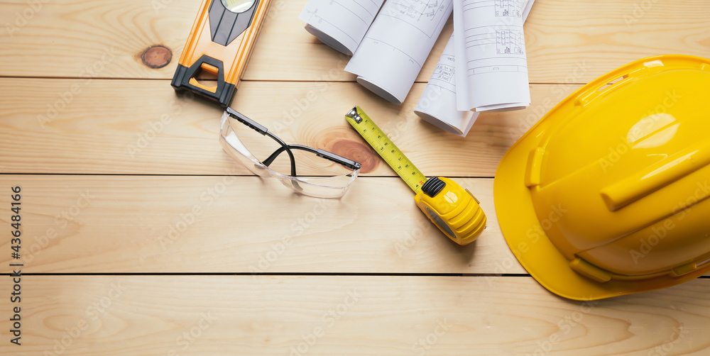 Work safety. Standard Construction site protective equipment on  top view wooden background, flat la