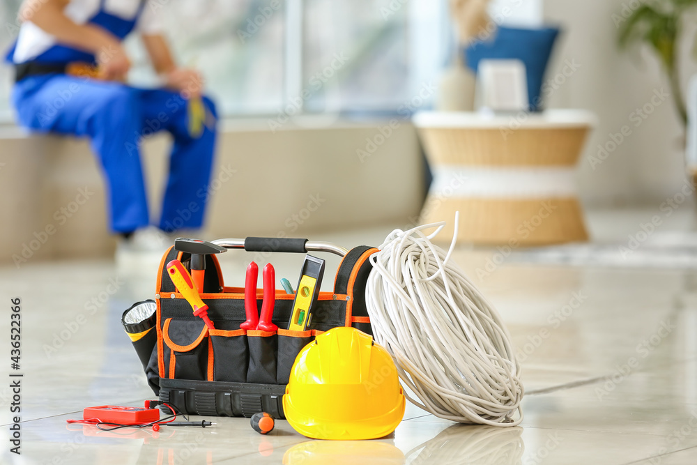 Electricians tools on floor in room