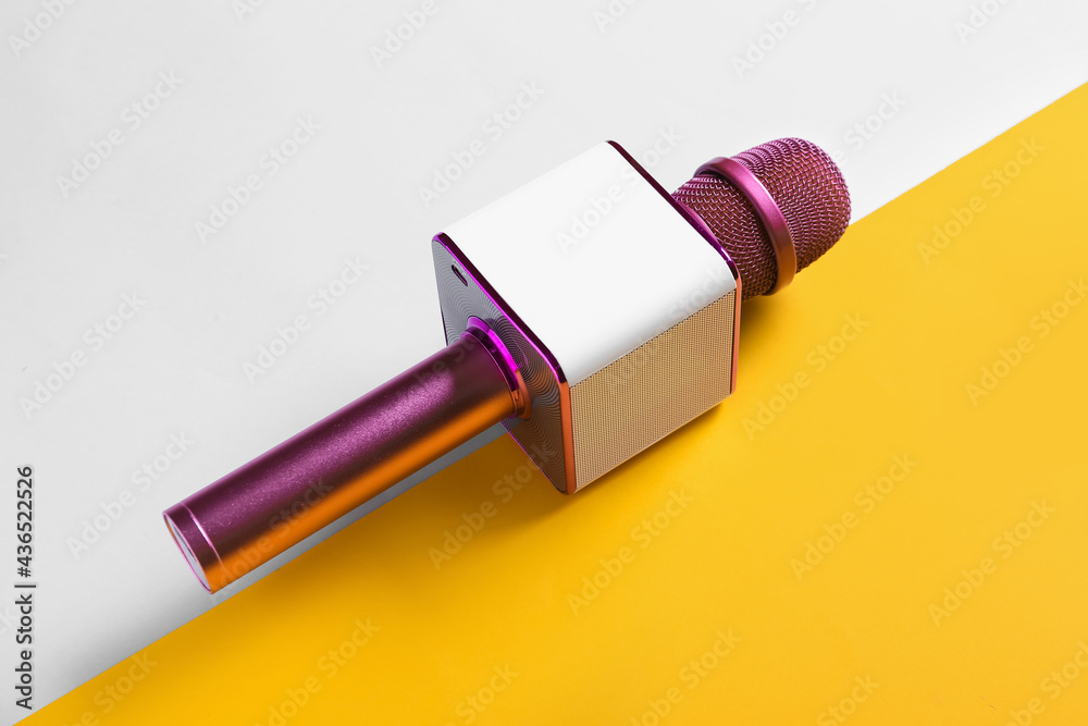 Modern microphone on color background