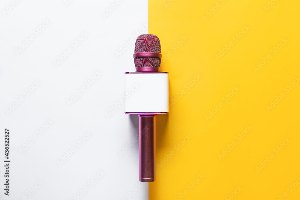 Modern microphone on color background