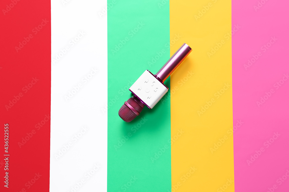 Modern microphone on color background