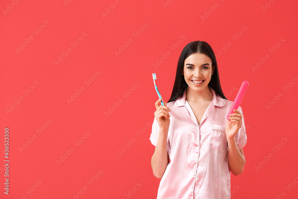 Beautiful woman with tooth brush and case on color background