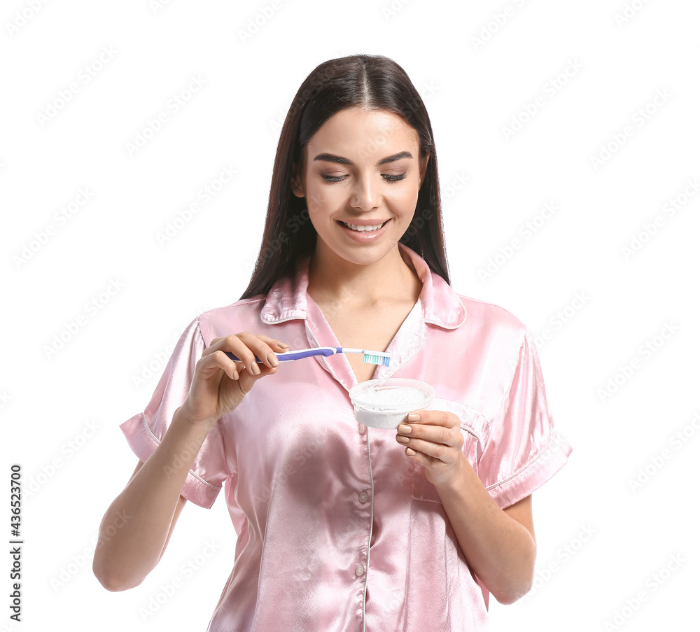 Beautiful woman brushing teeth on white background