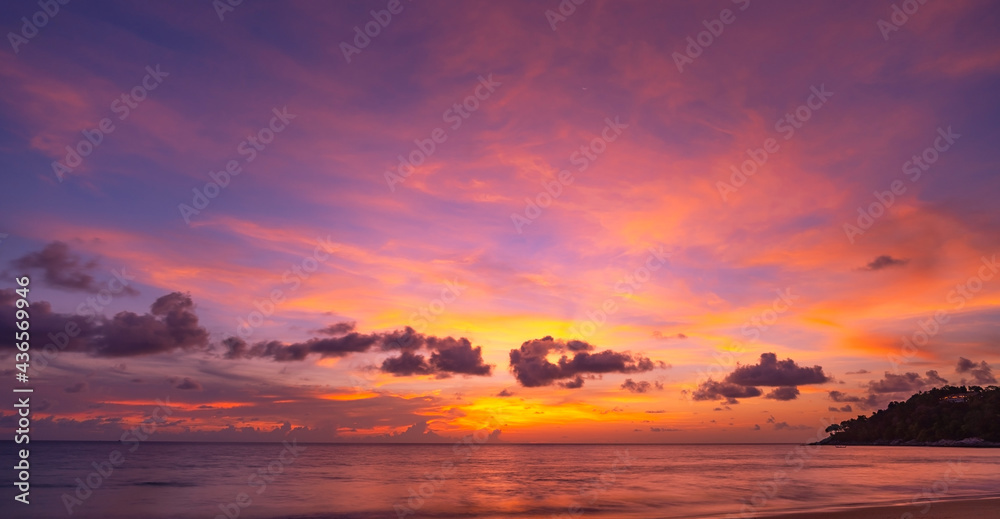 Landscape Long exposure of majestic clouds in the sky sunset or sunrise over sea with reflection in 