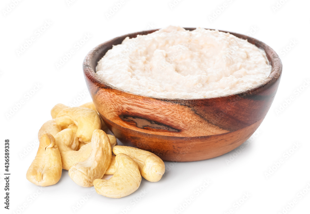 Bowl with cashew sour cream on white background